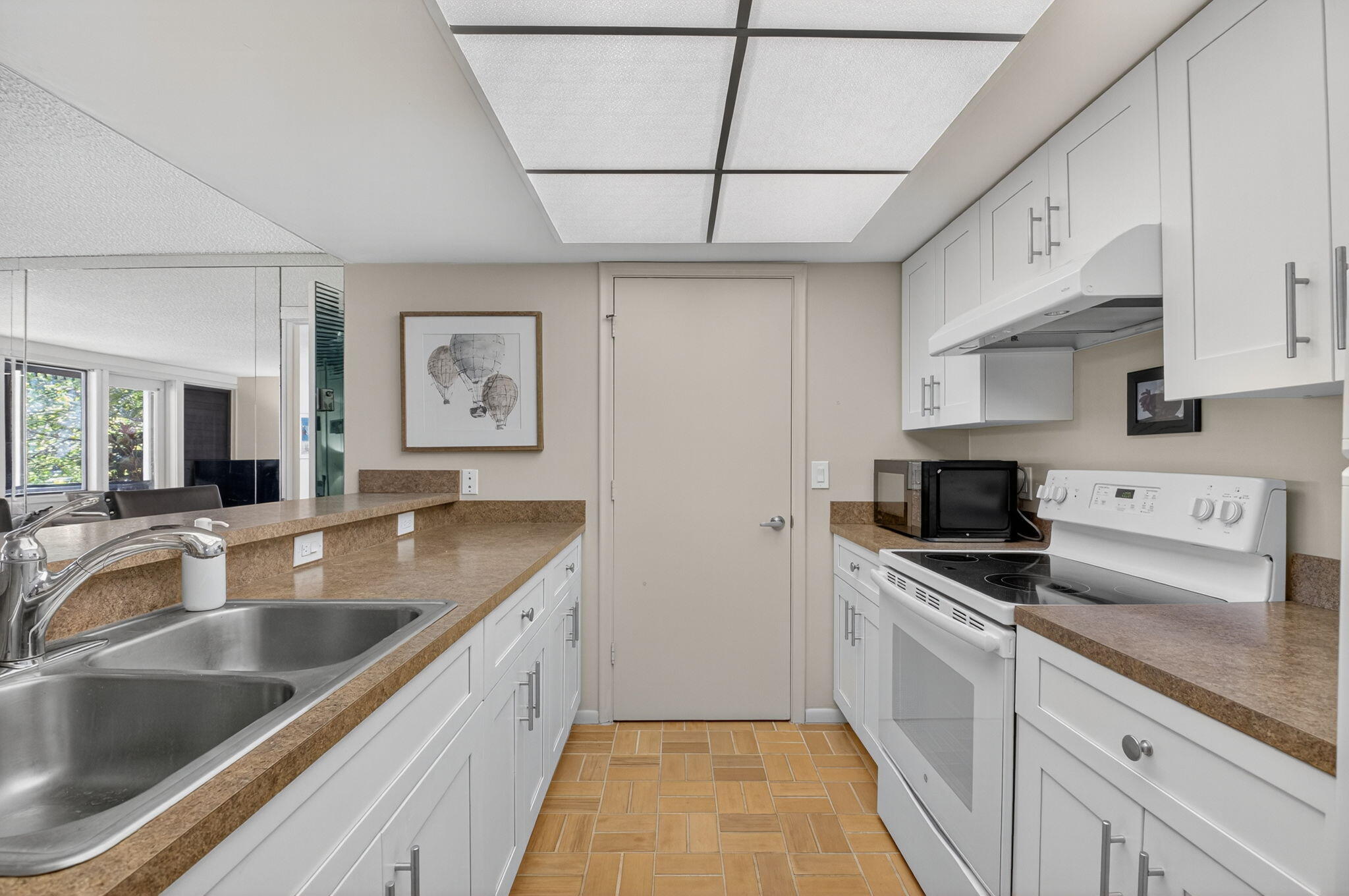 20249 Boca W Drive, Unit 2605 Boca Raton, FL 33434 - Photo 14 of 85 a kitchen with granite countertop a sink stainless steel appliances and white cabinets