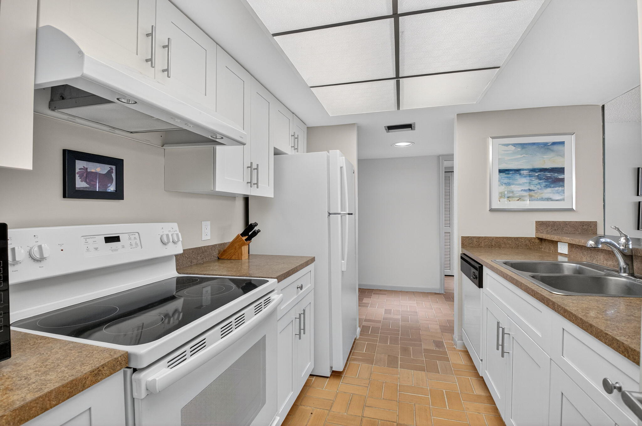 20249 Boca W Drive, Unit 2605 Boca Raton, FL 33434 - Photo 15 of 85 a kitchen that has a sink and a stove