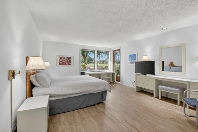 a view of a room that has a bed and a window