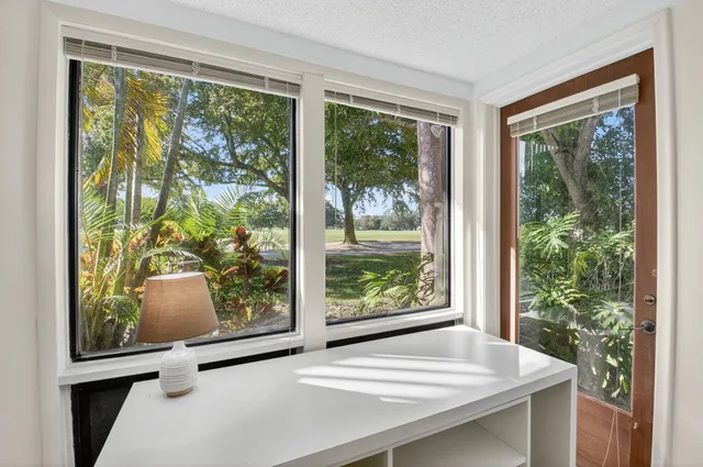 a spacious bedroom with a large bed and a large window