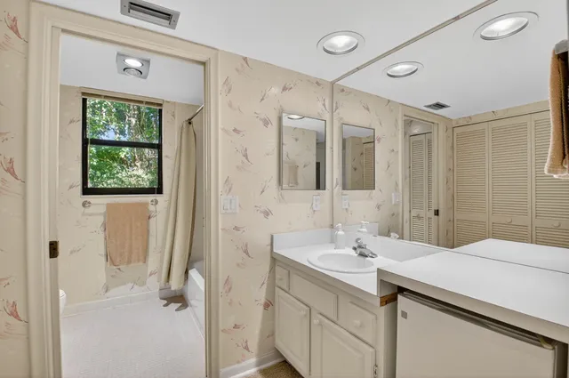 a bedroom with a bed and a large mirror