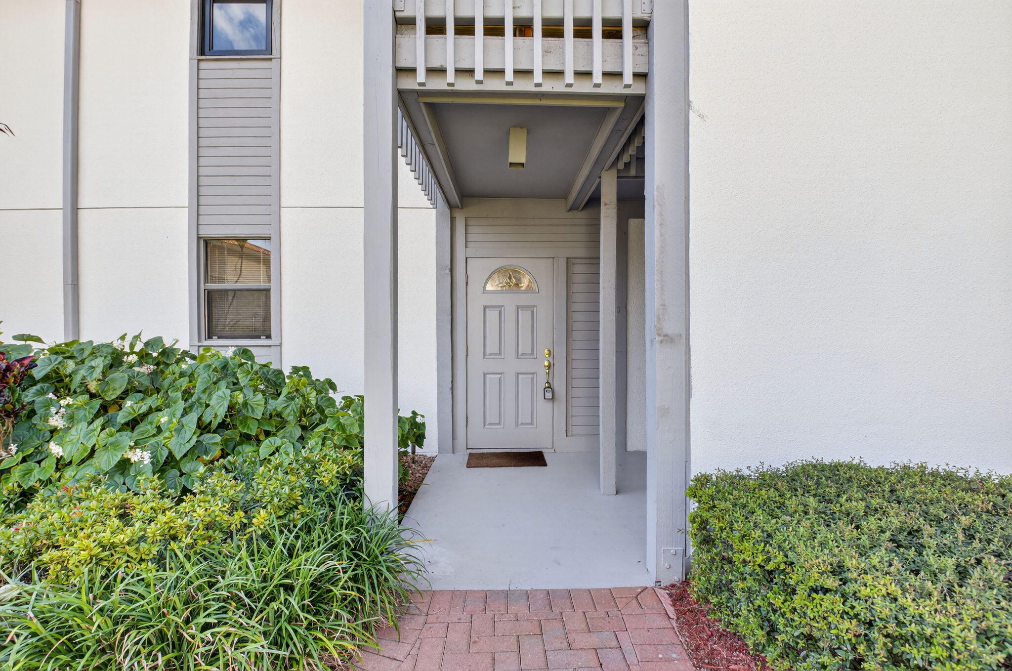 20249 Boca W Drive, Unit 2605 Boca Raton, FL 33434 - Photo 3 of 85 a view of a door of the house with a garden