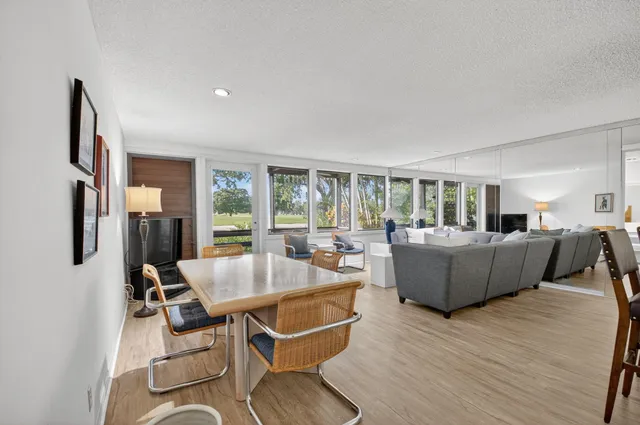 a kitchen with stainless steel appliances kitchen island granite countertop a refrigerator and a sink