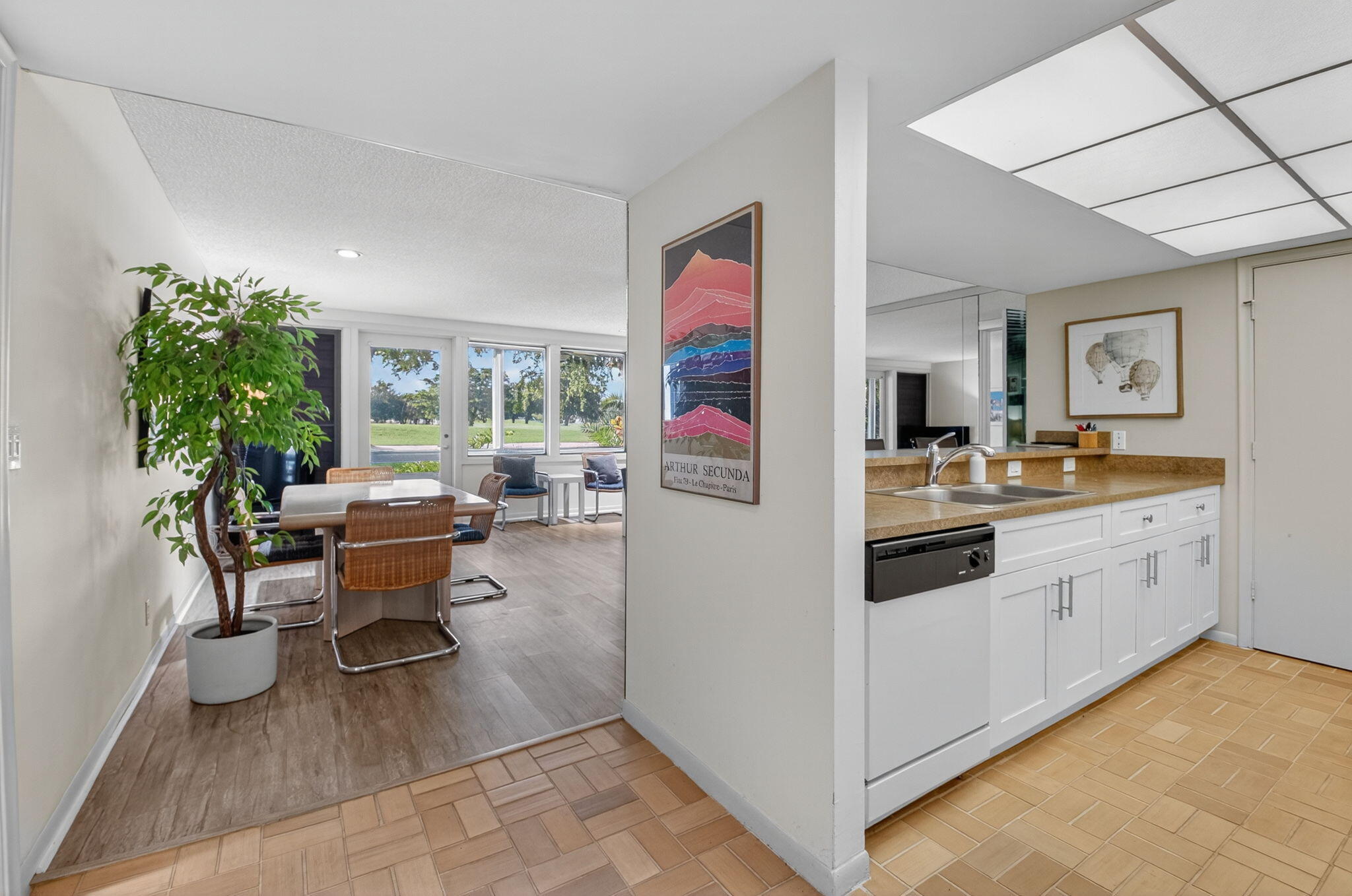 20249 Boca W Drive, Unit 2605 Boca Raton, FL 33434 - Photo 9 of 85 a kitchen with stainless steel appliances kitchen island granite countertop a refrigerator and a sink