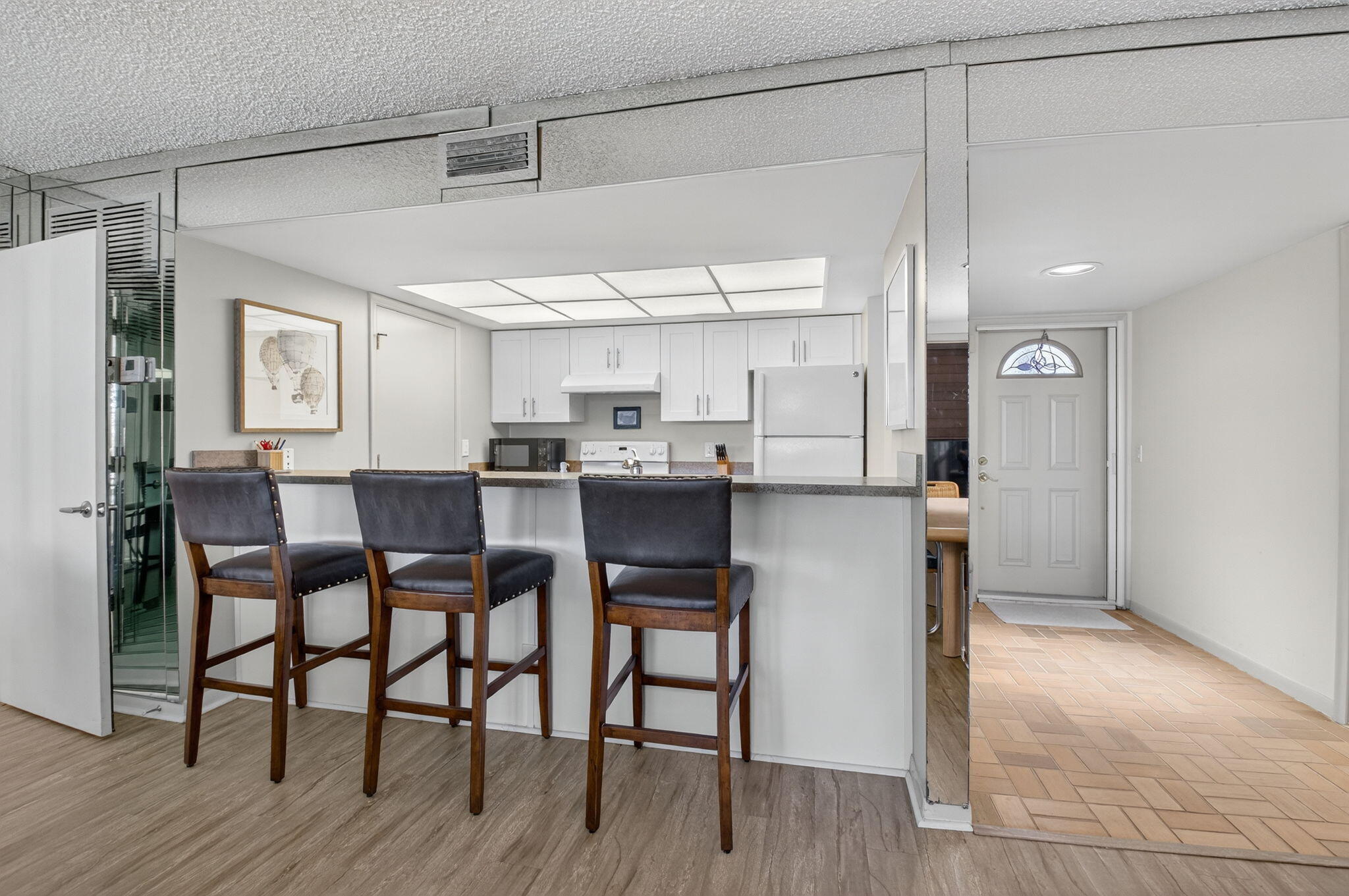 20249 Boca W Drive, Unit 2605 Boca Raton, FL 33434 - Photo 10 of 85 a kitchen with stainless steel appliances kitchen island granite countertop a table and chairs in it