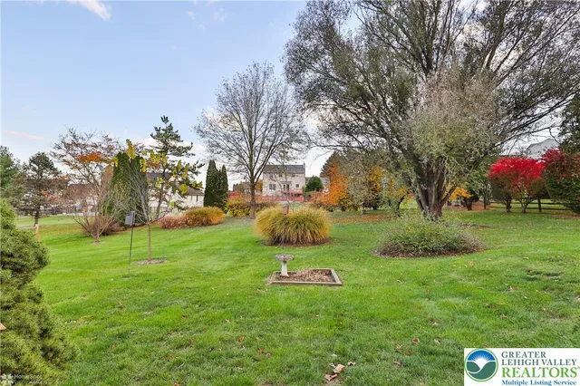 a view of an house with backyard space and garden
