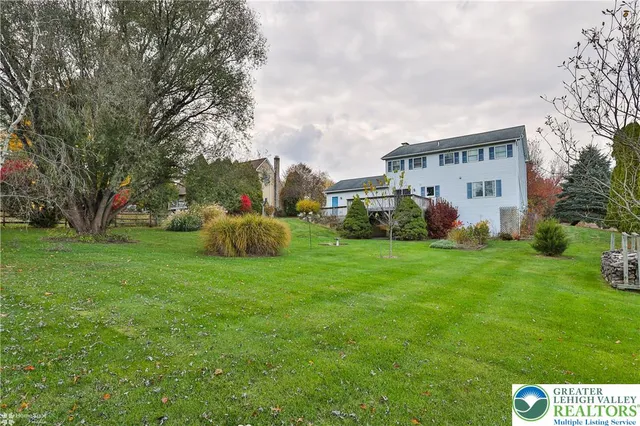 a aerial view of a house with pool and yard