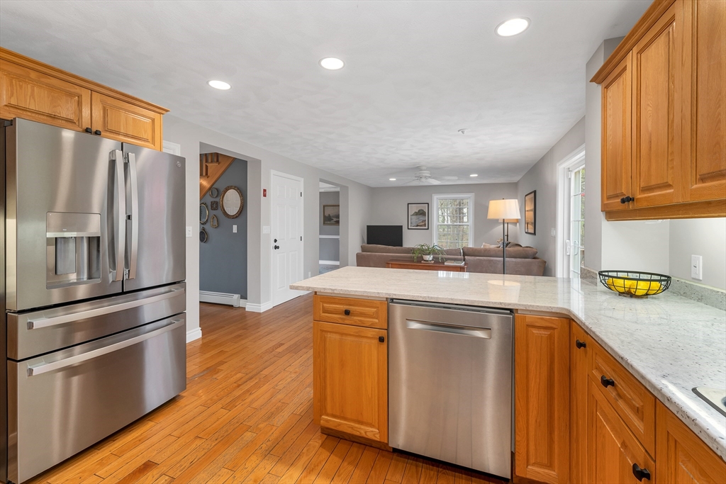 9 Juniper Ridge Road Exeter, NH 03833 - Photo 11 of 41 a kitchen with stainless steel appliances white cabinets and a refrigerator