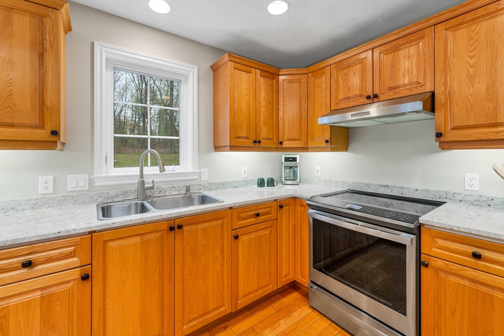9 Juniper Ridge Road Exeter, NH 03833 - Photo 12 of 41 a kitchen with granite countertop cabinets stainless steel appliances a sink and window