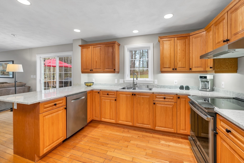 9 Juniper Ridge Road Exeter, NH 03833 - Photo 13 of 41 a kitchen with stainless steel appliances granite countertop sink stove top oven and cabinets