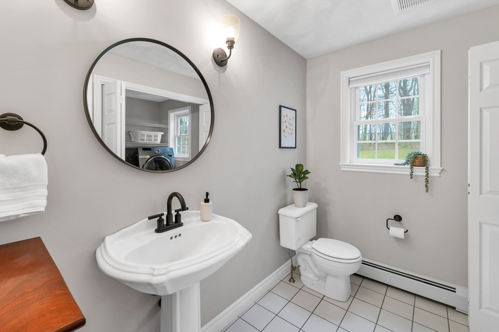 9 Juniper Ridge Road Exeter, NH 03833 - Photo 20 of 41 a bathroom with a sink a toilet and a mirror
