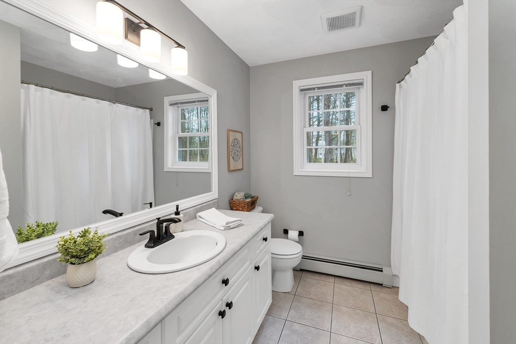 9 Juniper Ridge Road Exeter, NH 03833 - Photo 30 of 41 a bathroom with a sink double vanity and a mirror