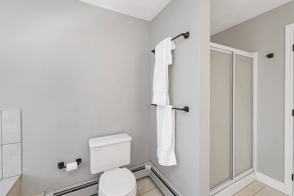 9 Juniper Ridge Road Exeter, NH 03833 - Photo 31 of 41 a white toilet sitting next to a bathroom sink