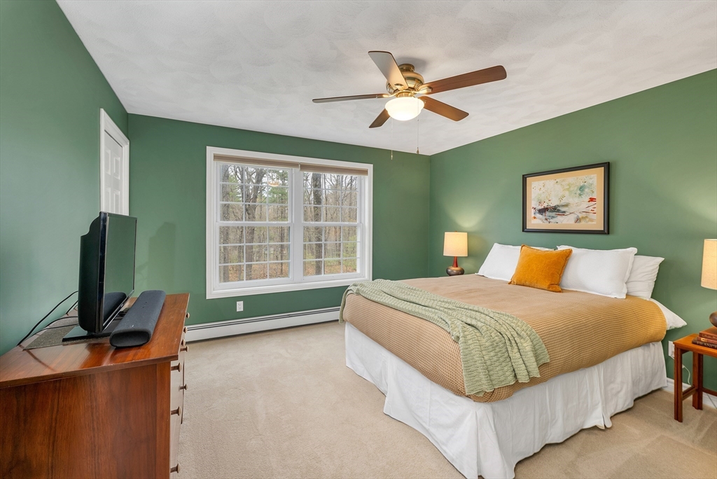 9 Juniper Ridge Road Exeter, NH 03833 - Photo 36 of 41 a bedroom with a bed and a flat screen tv