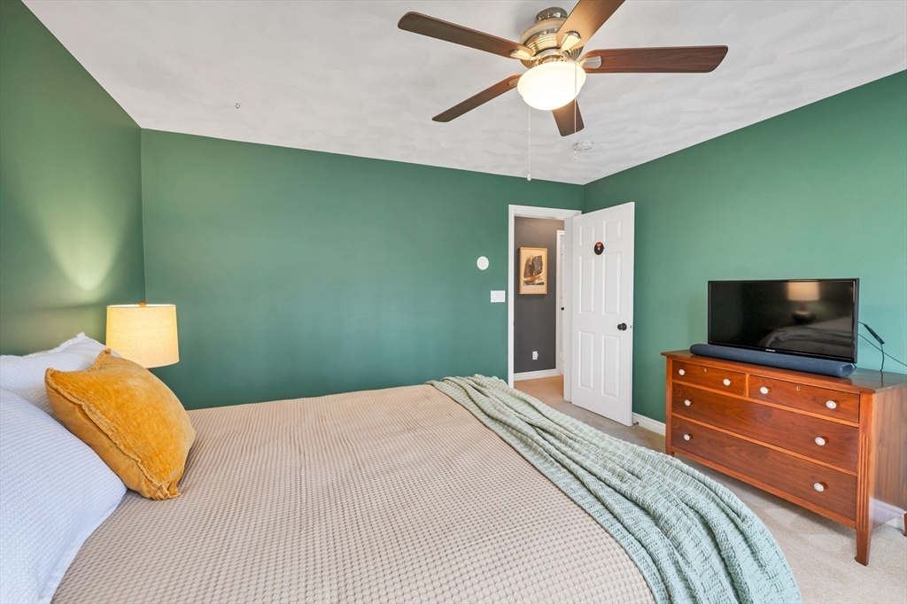 9 Juniper Ridge Road Exeter, NH 03833 - Photo 37 of 41 a bedroom with a bed and a television