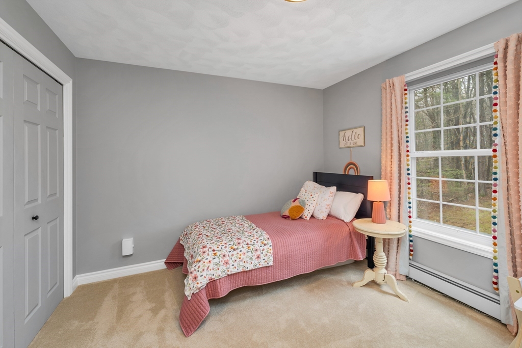 9 Juniper Ridge Road Exeter, NH 03833 - Photo 38 of 41 a bedroom with a bed and a window