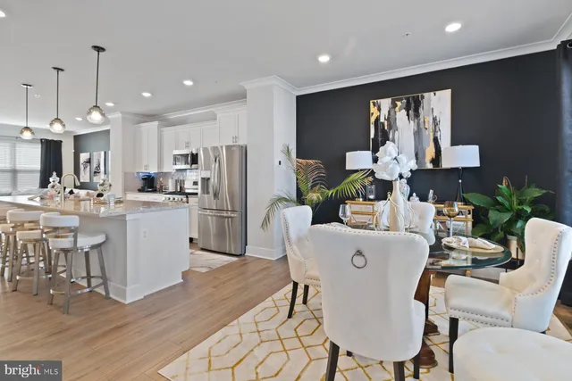 a kitchen with kitchen island a appliances dining table and chairs