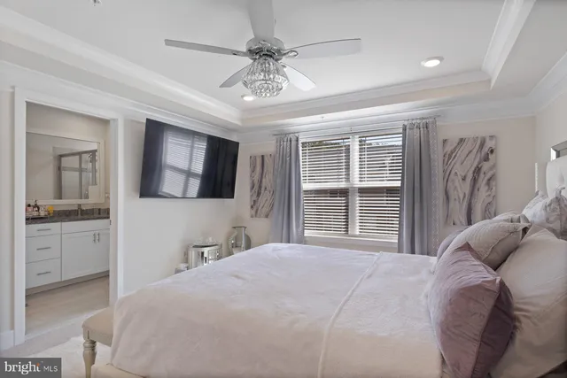 a bedroom with a large bed and a tv