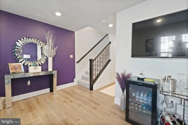 a view of hall way with furniture and paintings on the wall
