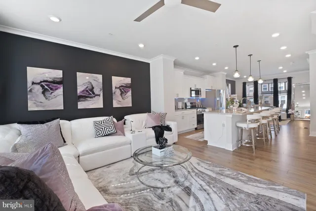 a living room with furniture and kitchen view