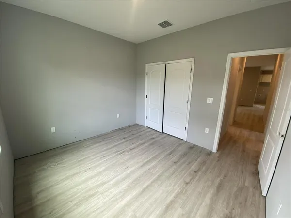 a view of an empty room and wooden floor