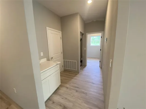 a view of a hallway with wooden floor