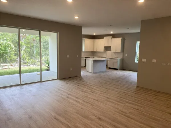 a view of a kitchen with wooden floor and a sink