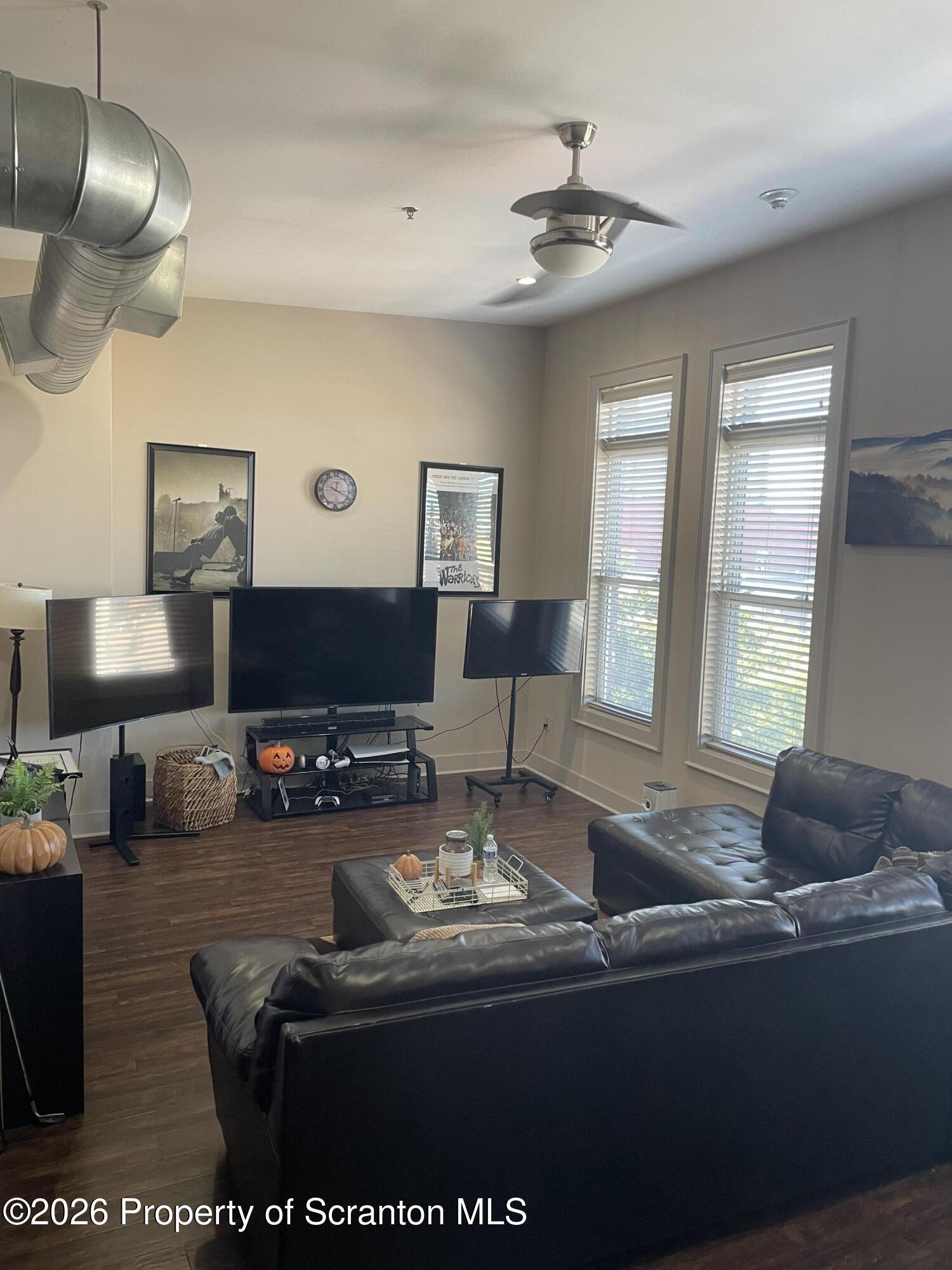322 Penn Avenue, Unit 11 Scranton, PA 18503 - Photo 2 of 7 a living room with furniture and a flat screen tv