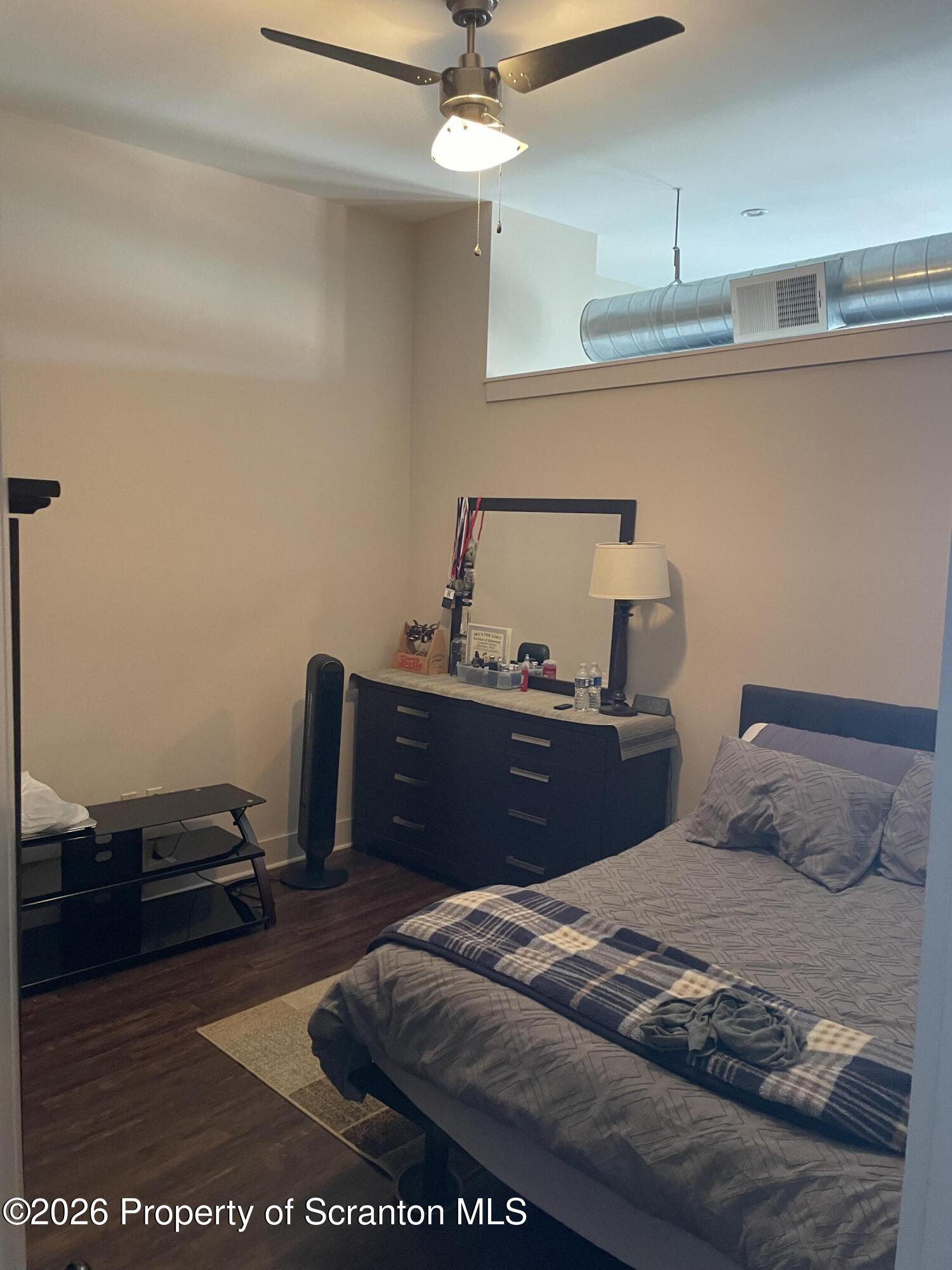 322 Penn Avenue, Unit 11 Scranton, PA 18503 - Photo 5 of 7 a bedroom with a bed and a table