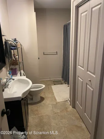 a bathroom with a sink toilet and shower