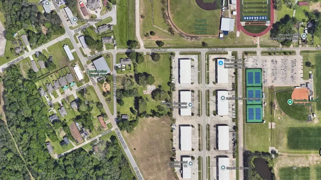 aerial view of a residential apartment building with a yard