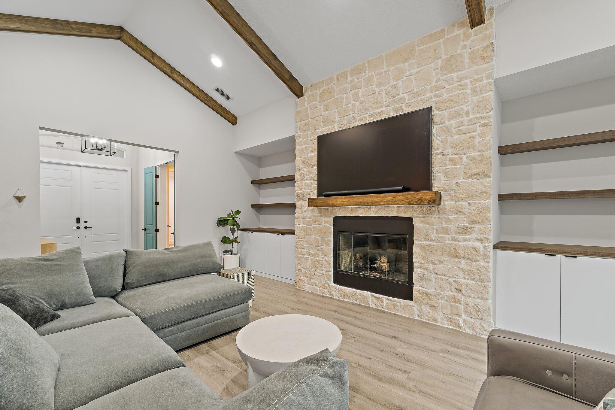 12216 175th Road North Jupiter, FL 33478 - Photo 11 of 57 a living room with furniture a fireplace and a flat screen tv