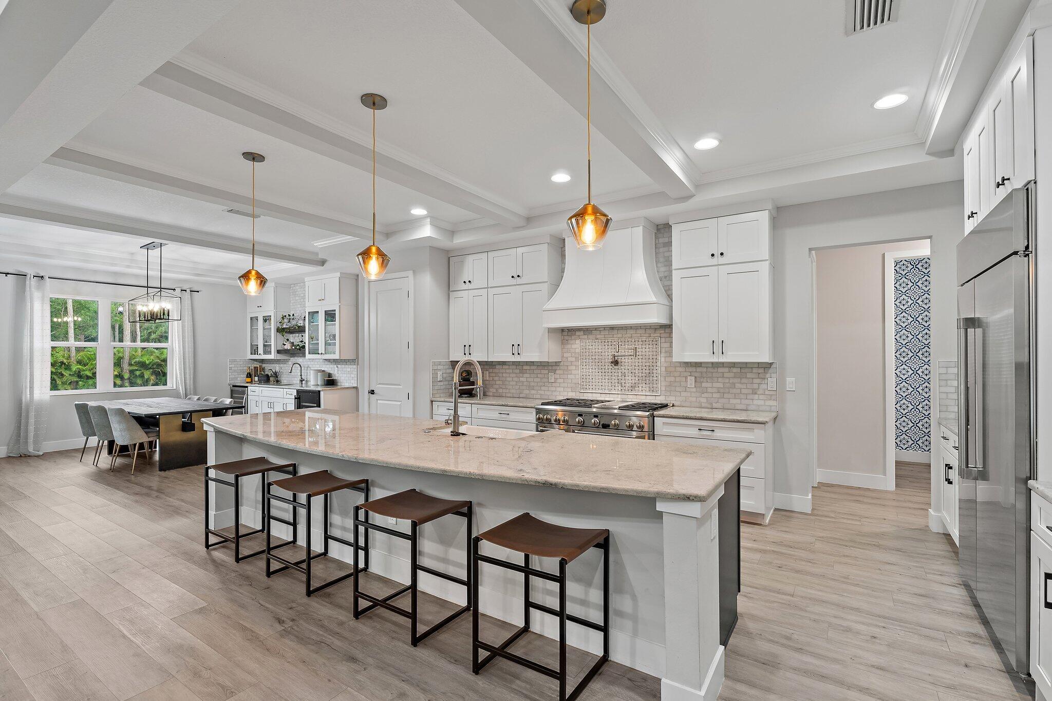12216 175th Road North Jupiter, FL 33478 - Photo 15 of 57 a large kitchen with a table and chairs in it
