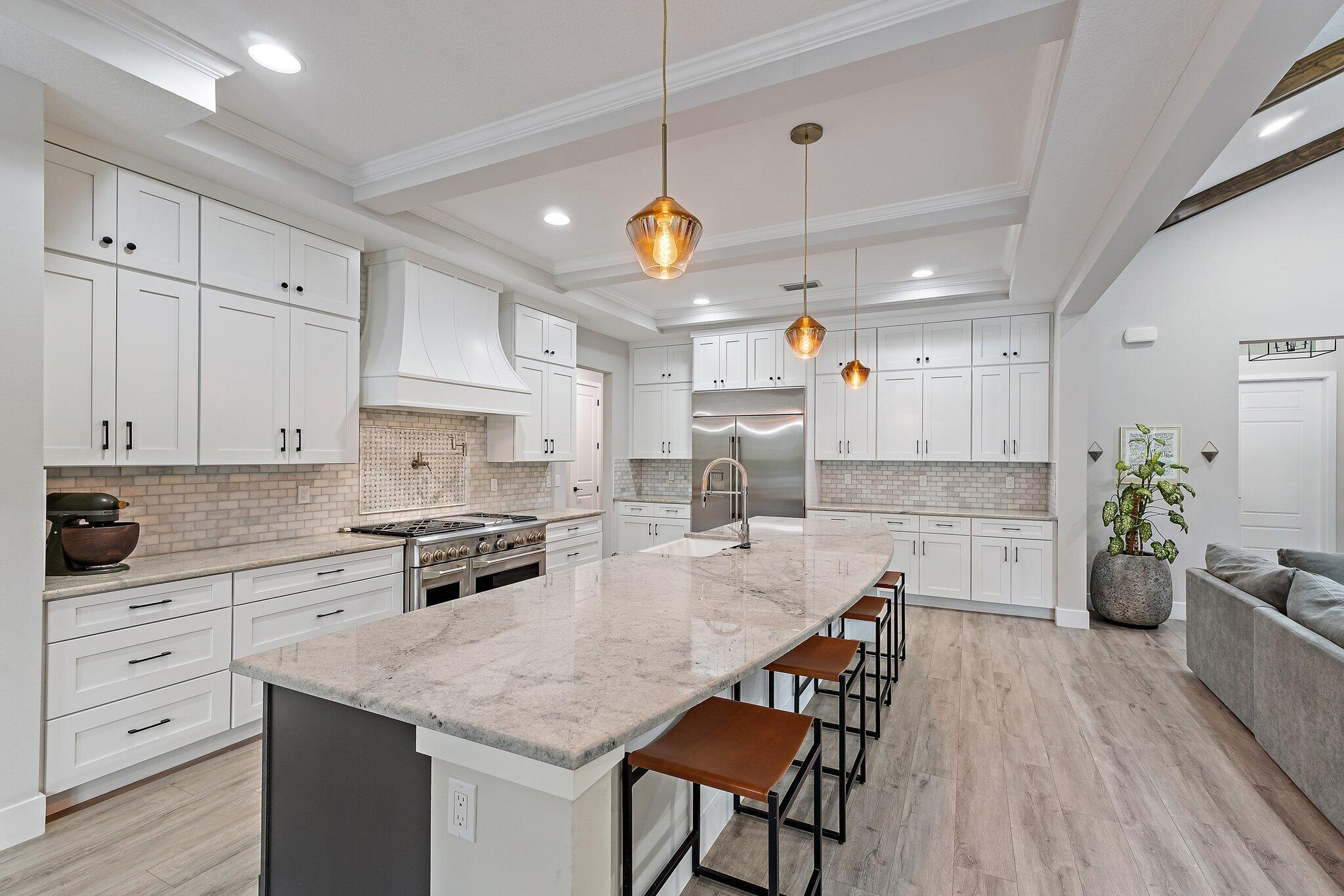 12216 175th Road North Jupiter, FL 33478 - Photo 16 of 57 a kitchen with white cabinets and stainless steel appliances