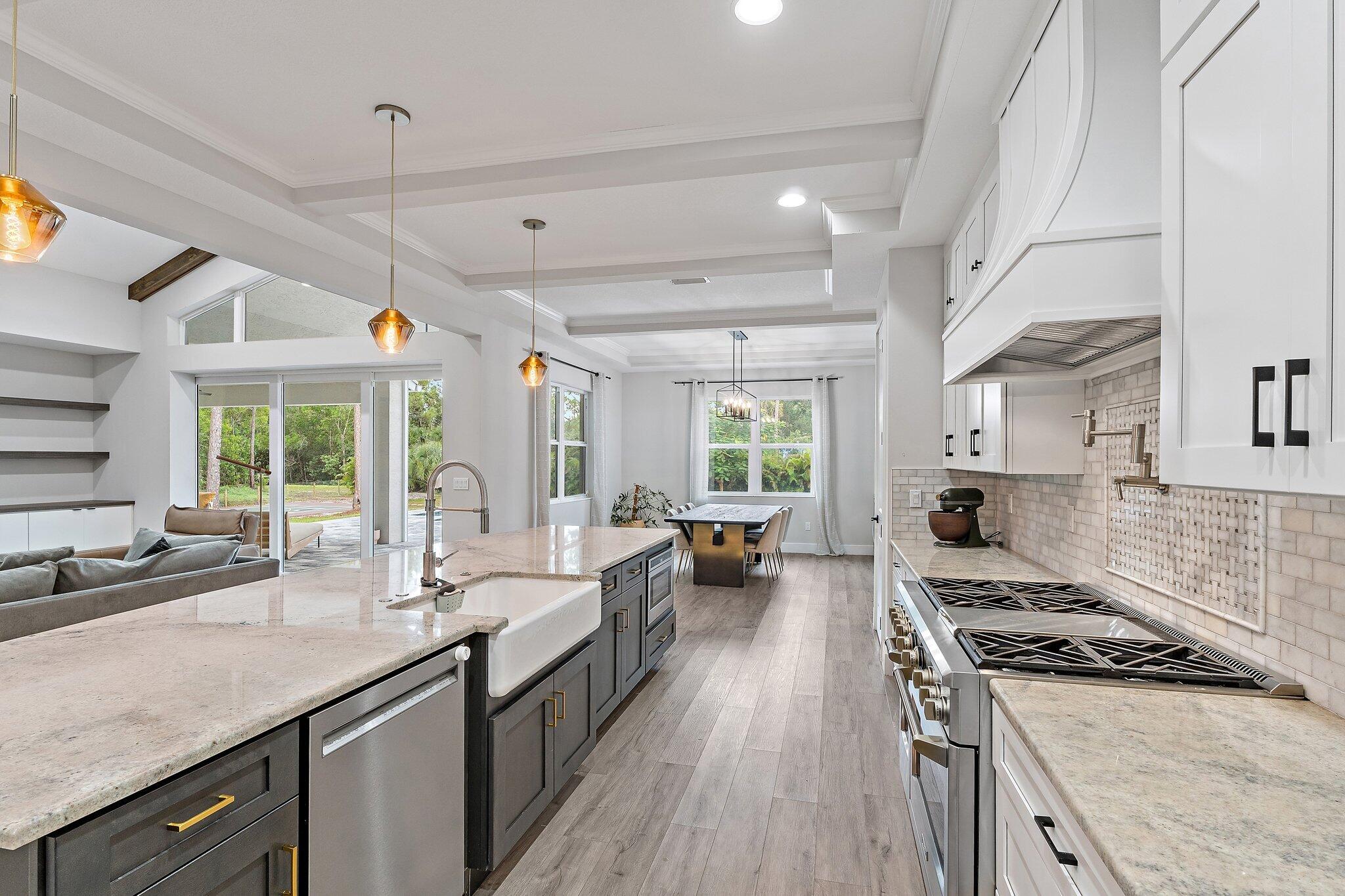 12216 175th Road North Jupiter, FL 33478 - Photo 18 of 57 a kitchen with sink stove and cabinets