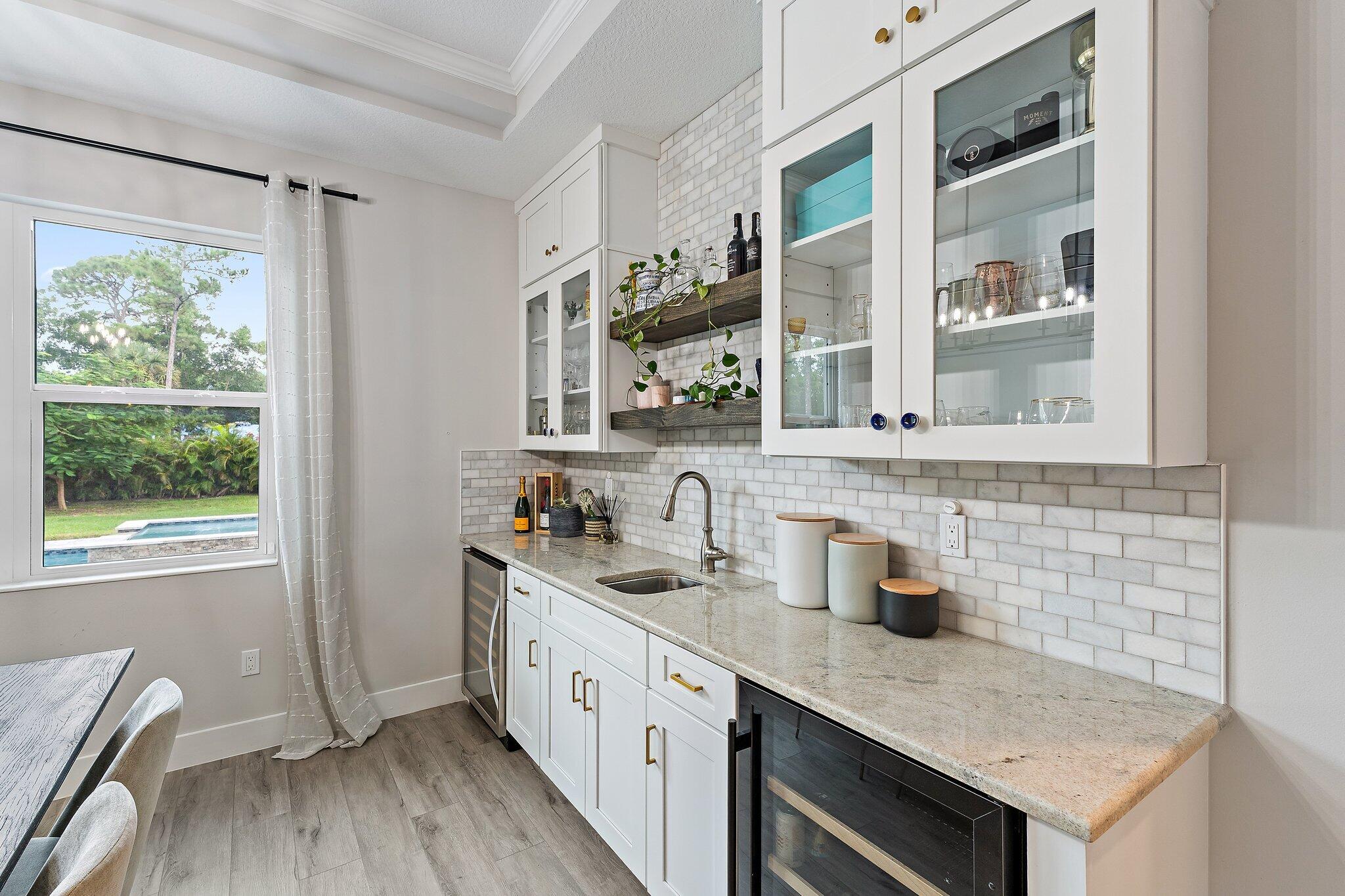 12216 175th Road North Jupiter, FL 33478 - Photo 20 of 57 a kitchen with a sink stove and cabinets