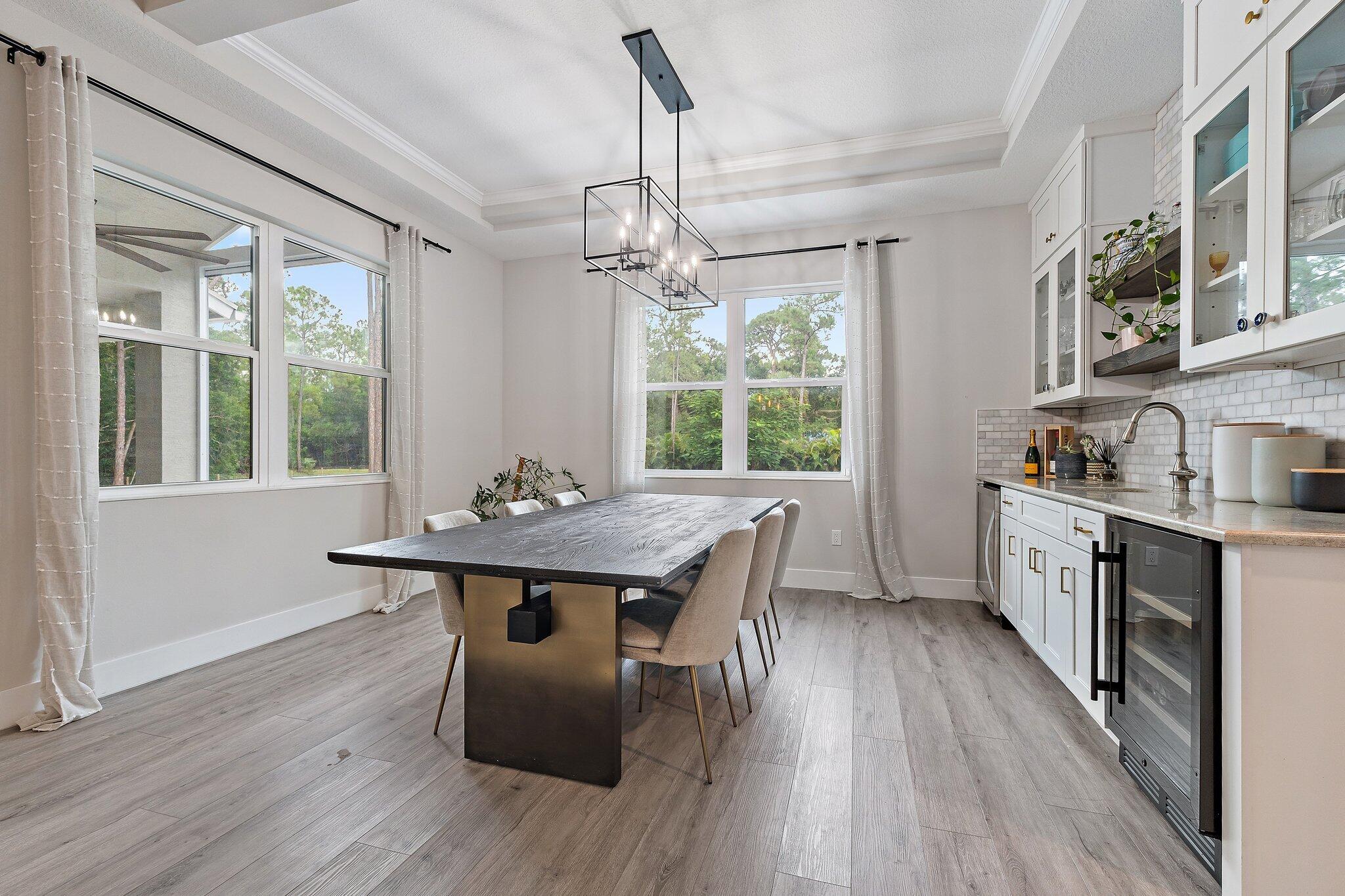 12216 175th Road North Jupiter, FL 33478 - Photo 21 of 57 a view of a dining room with furniture window and wooden floor