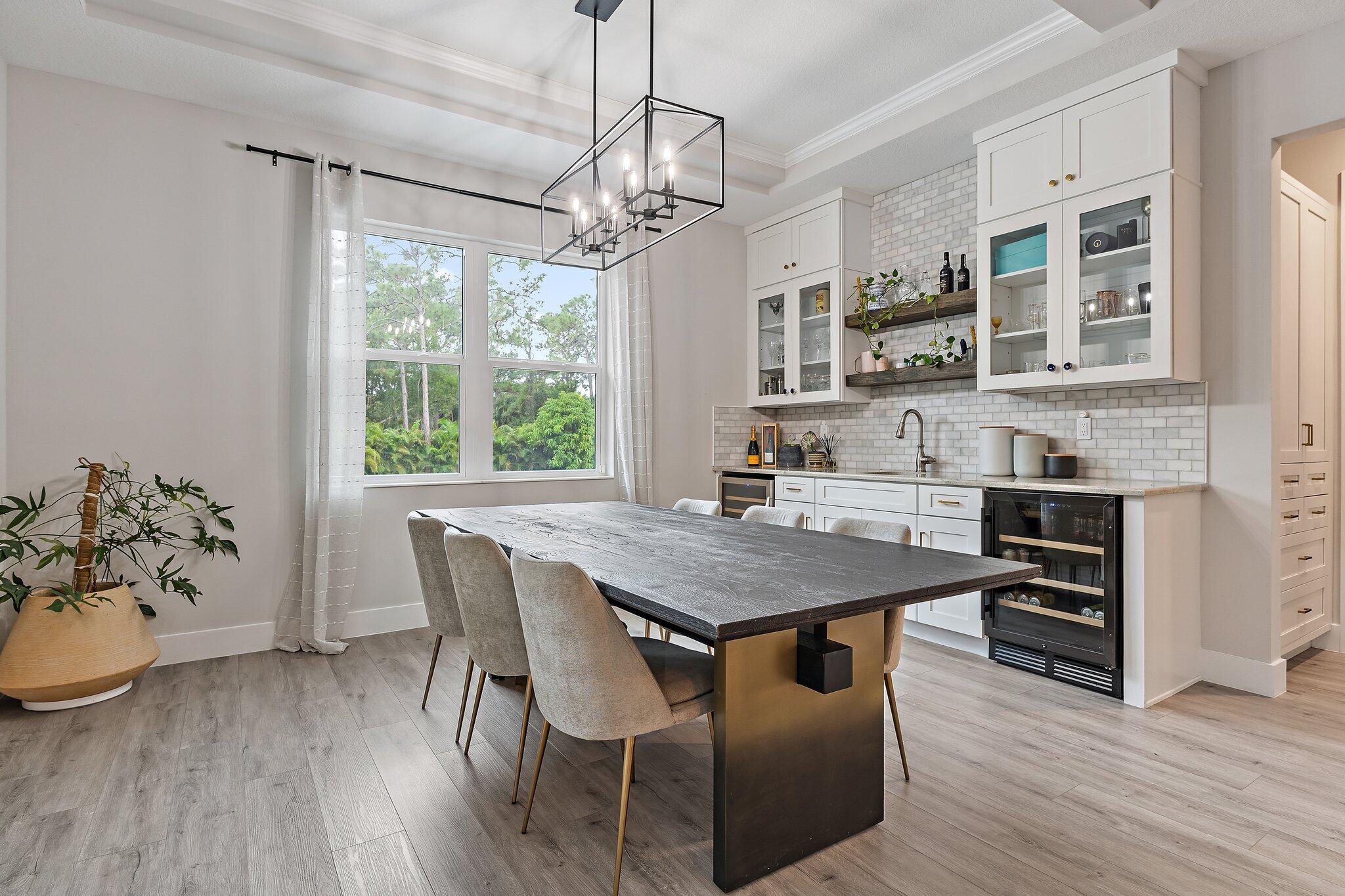 12216 175th Road North Jupiter, FL 33478 - Photo 22 of 57 a view of a dining room with furniture window and wooden floor