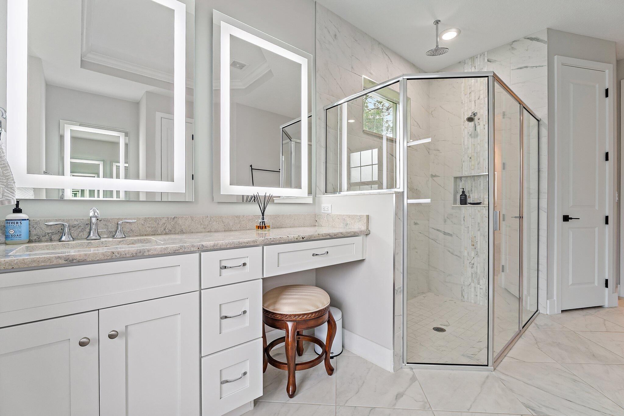 12216 175th Road North Jupiter, FL 33478 - Photo 29 of 57 a bathroom with a granite countertop sink a shower and a mirror