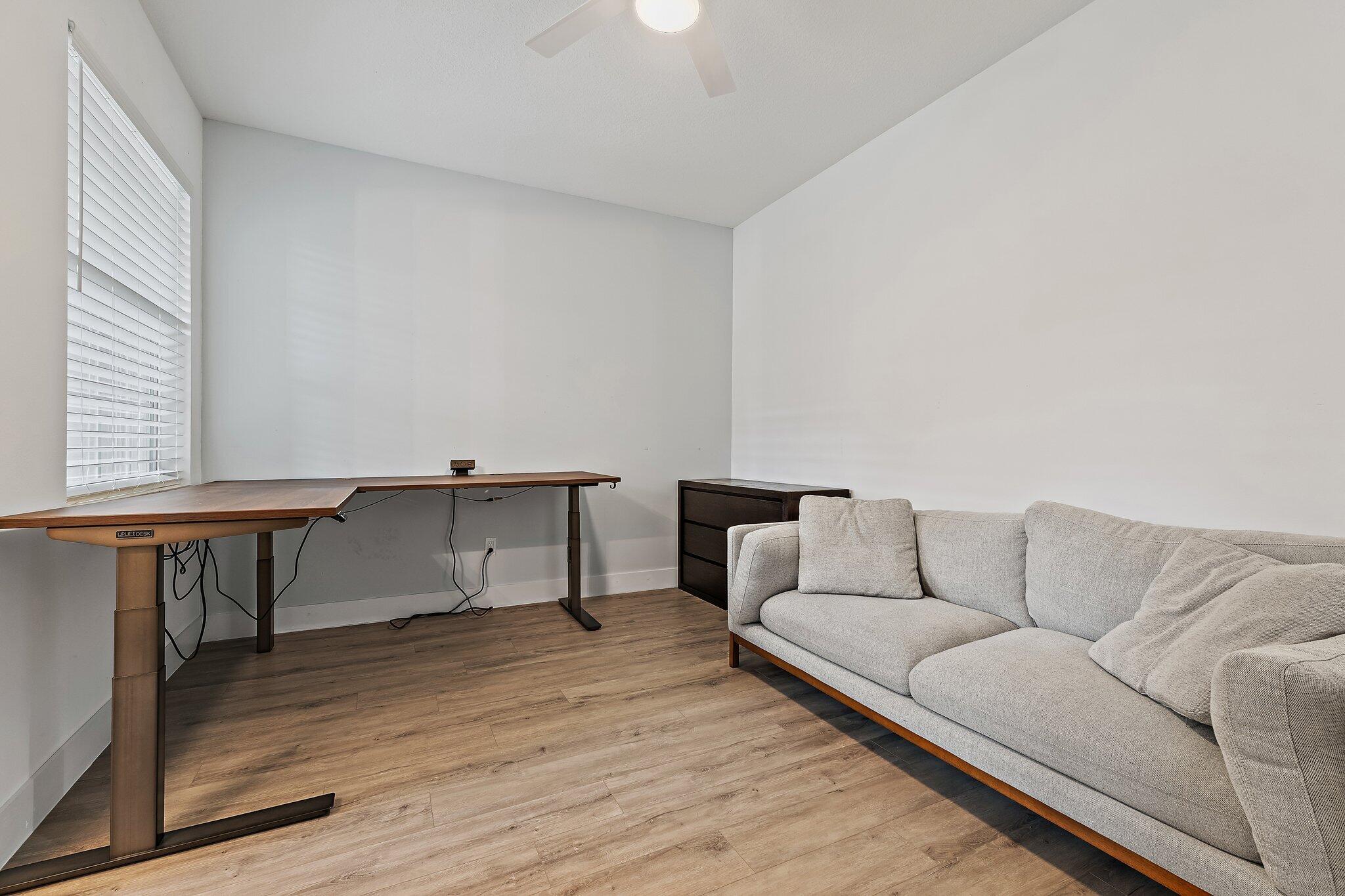 12216 175th Road North Jupiter, FL 33478 - Photo 40 of 57 a living room with furniture and a wooden floor
