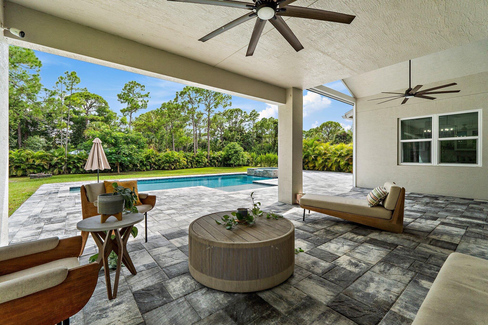 12216 175th Road North Jupiter, FL 33478 - Photo 45 of 57 a living room with furniture and a floor to ceiling window
