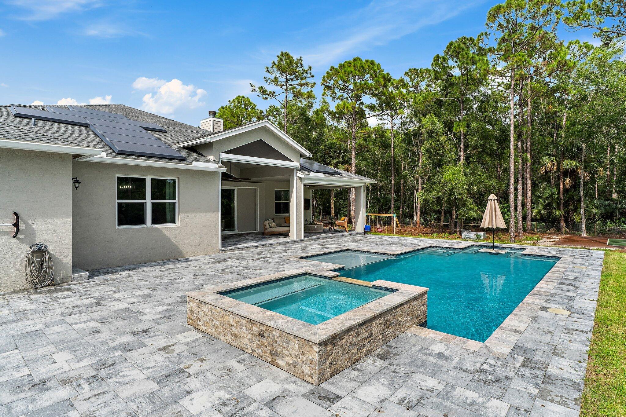 12216 175th Road North Jupiter, FL 33478 - Photo 49 of 57 a front view of a house with garden
