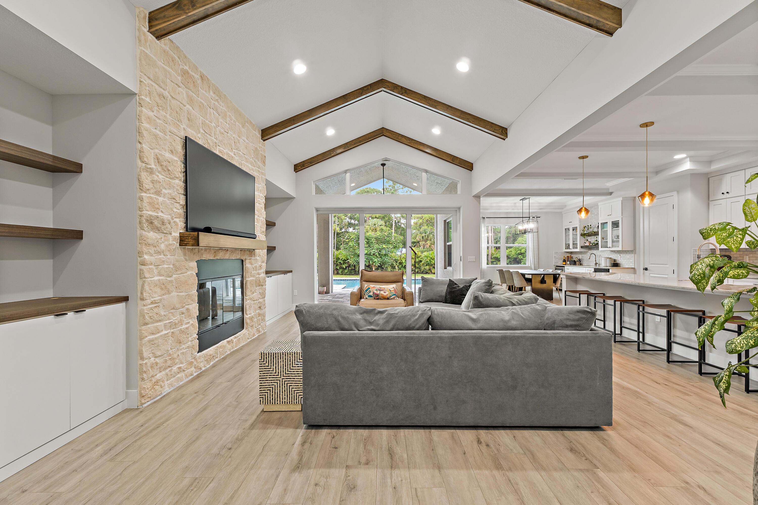 12216 175th Road North Jupiter, FL 33478 - Photo 5 of 57 a living room with fireplace furniture and a flat screen tv