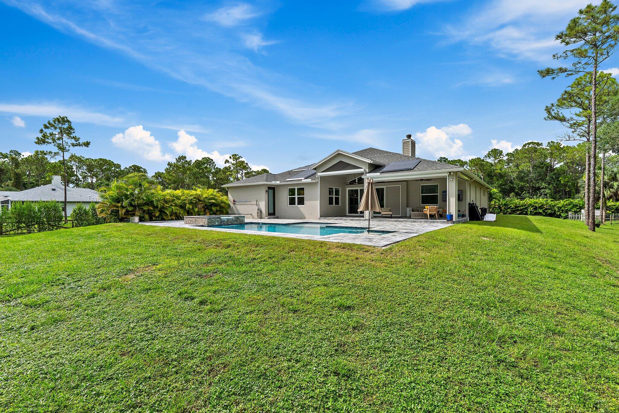 12216 175th Road North Jupiter, FL 33478 - Photo 51 of 57 a front view of a house with garden