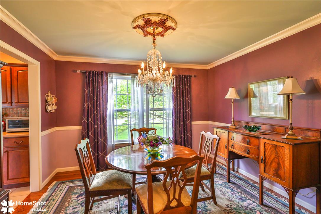 4191 Walter Road Bethlehem, PA 18020 - Photo 7 of 23 A classic dining room with a sparkling chandelier and a traditional wooden table, perfect for gatherings.