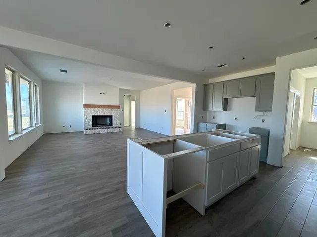 a kitchen with stainless steel appliances granite countertop a sink and a refrigerator