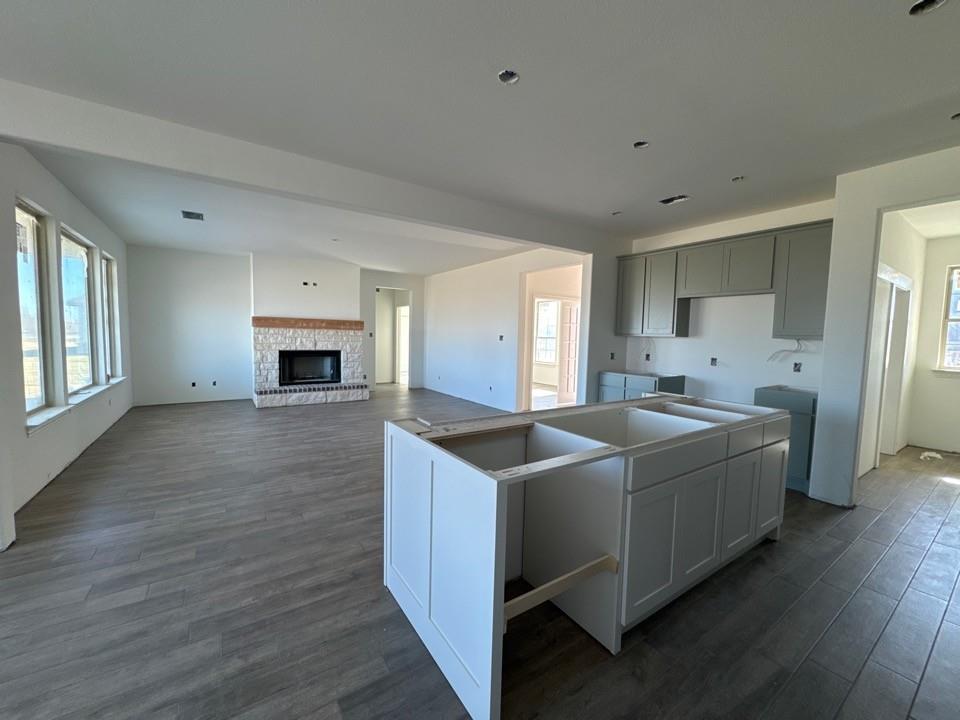 130 Fossil Canyon Drive Rhome, TX 76078 - Photo 7 of 15 a kitchen with stainless steel appliances granite countertop a sink and a refrigerator
