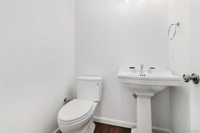 a bathroom with a sink toilet and a mirror