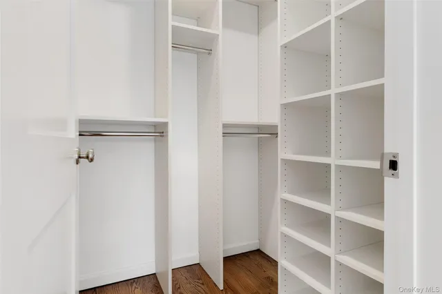 a view of walk in closet with empty racks