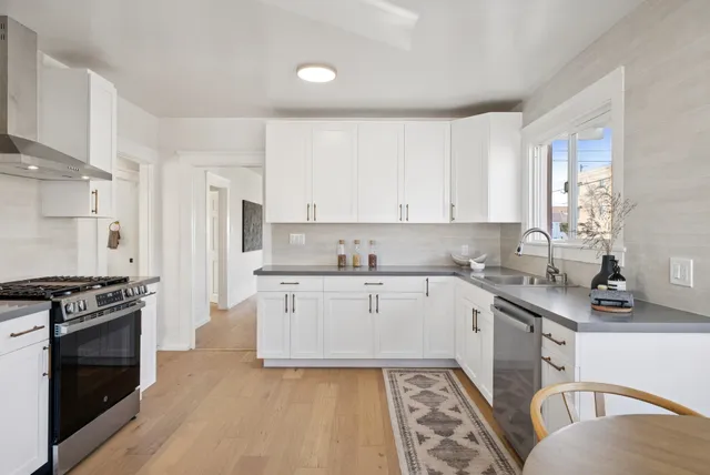 a kitchen with a sink stove top oven and refrigerator